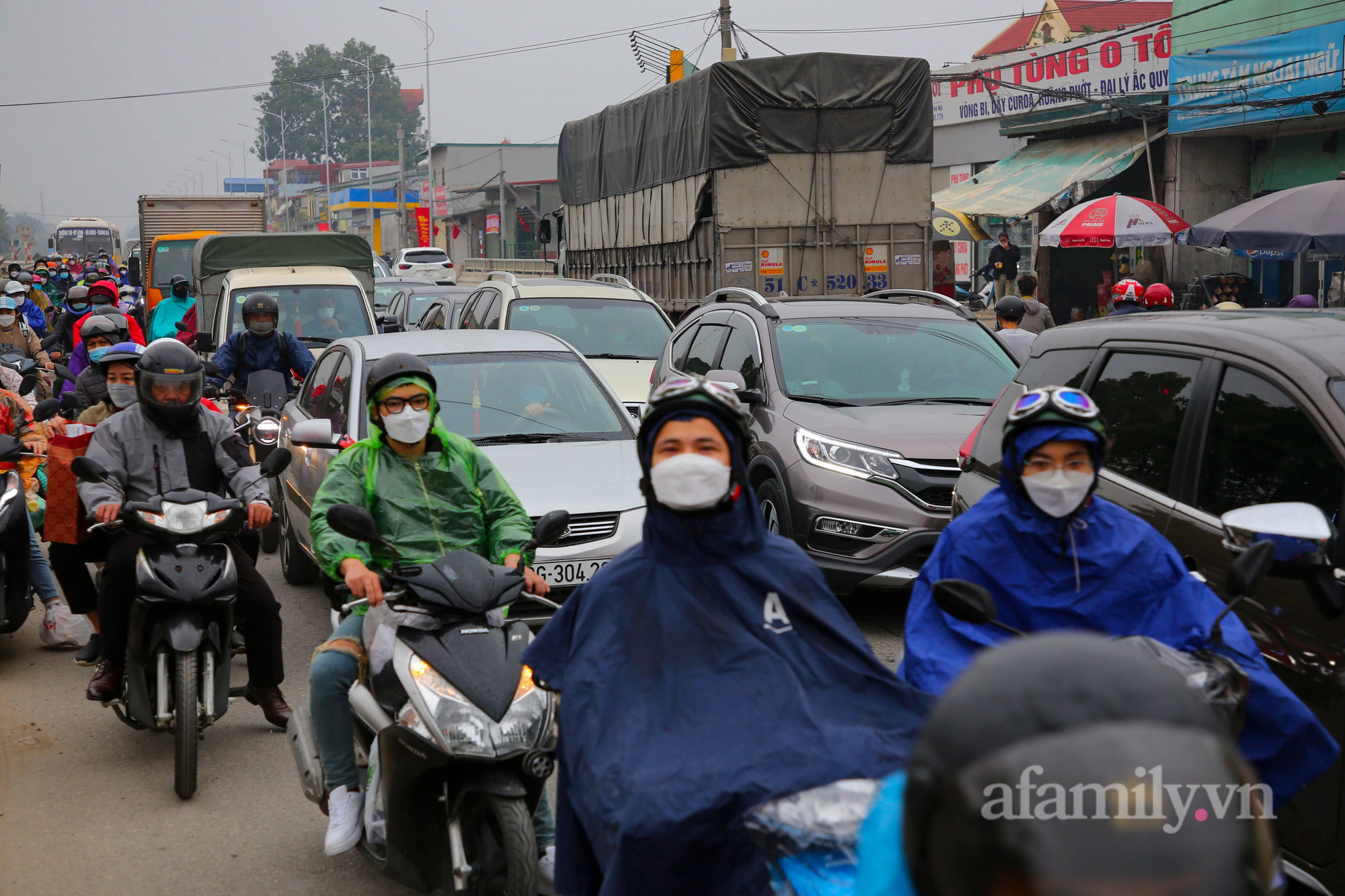 Hà Nội: Hàng nghìn người chạy xe máy trùm kín áo mưa, ùn ùn rời phố về quê ăn Tết - Ảnh 8.