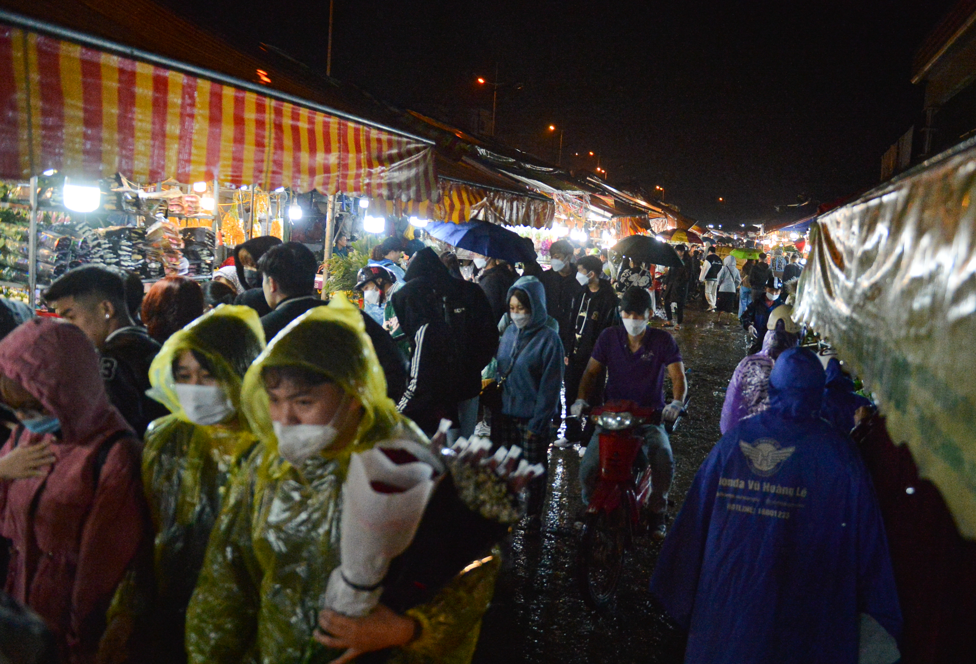 Ảnh: Mặc áo mưa, đội ô đi chợ hoa đêm lớn nhất miền Bắc trước ngày Phụ nữ Việt Nam 20/10, nhiều người co ro vì lạnh - Ảnh 2.