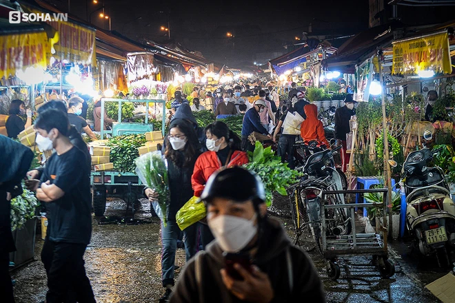 Nhiều ông chồng đội mưa rét lên chợ đêm Quảng An mua hoa tặng chị em phụ nữ - Ảnh 1.
