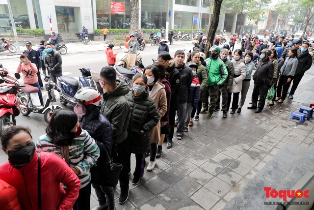 Dân Hà nội xếp hàng dài dưới đường đợi mua khẩu trang giá rẻ - Ảnh 2.
