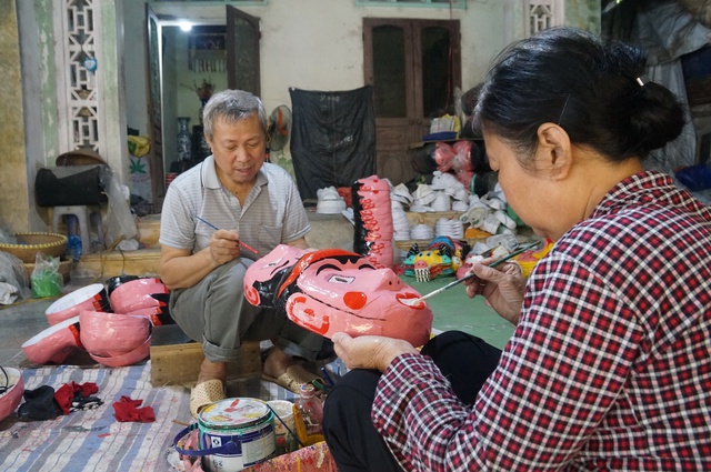 Nghệ nhân làng nghề Ông Hảo đang tô vẽ mặt nạ