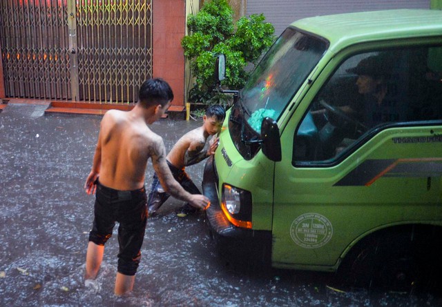 Hà Nội mưa trắng trời, phố phường ngập lụt, xe cộ &quot;bì bõm&quot; lội trong nước  - Ảnh 10.
